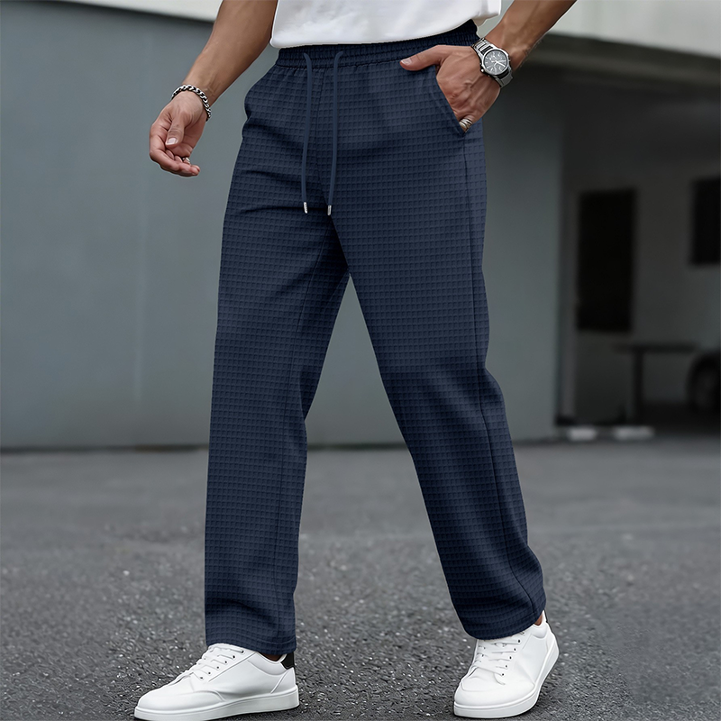 Navy blue men's waffle-knit drawstring casual pants – styled front view