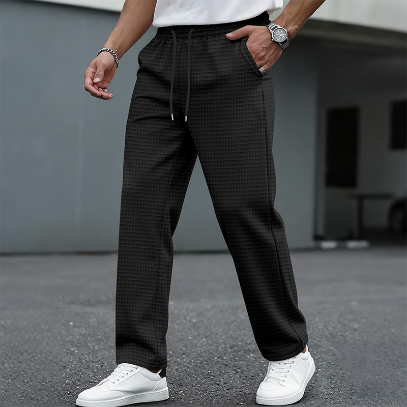 Black men's waffle-knit drawstring casual pants – styled front view